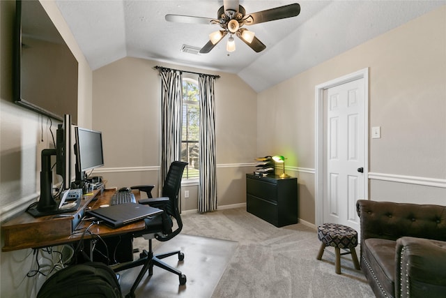 office featuring light colored carpet, baseboards, visible vents, a ceiling fan, and lofted ceiling