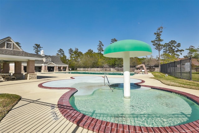 pool with fence and a patio