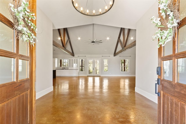 entrance foyer featuring baseboards, french doors, concrete floors, high vaulted ceiling, and beam ceiling