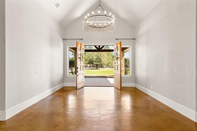 entryway featuring a notable chandelier, finished concrete floors, and a wealth of natural light