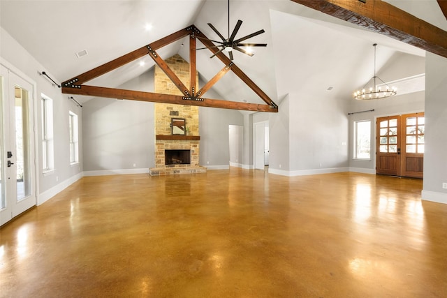 unfurnished living room featuring finished concrete floors, a fireplace, baseboards, and beamed ceiling