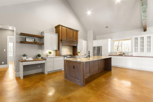 kitchen featuring open shelves, tasteful backsplash, finished concrete floors, freestanding refrigerator, and white cabinets