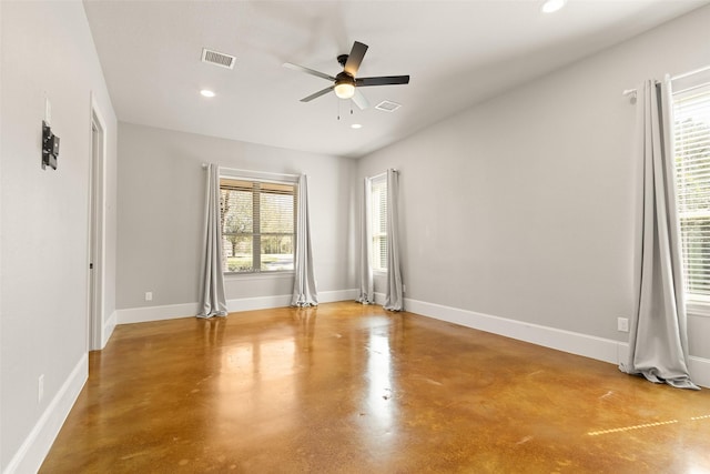 spare room featuring finished concrete floors, recessed lighting, visible vents, and baseboards