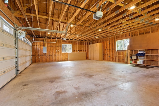 garage with electric panel and a garage door opener