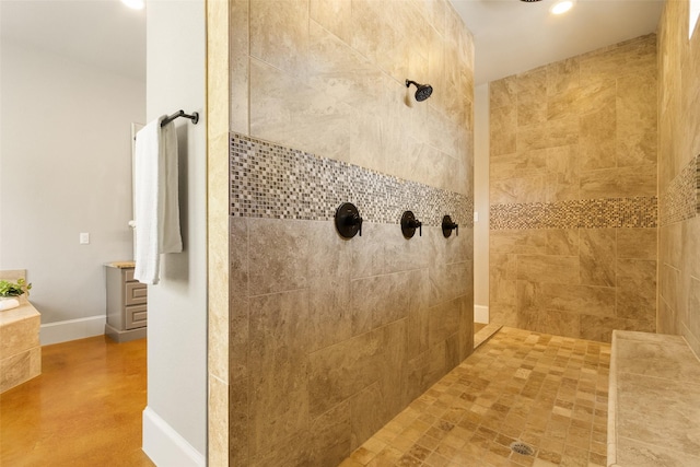 full bathroom featuring recessed lighting, a tile shower, and baseboards