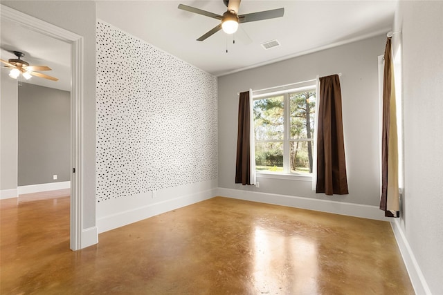 empty room with baseboards, visible vents, and finished concrete floors