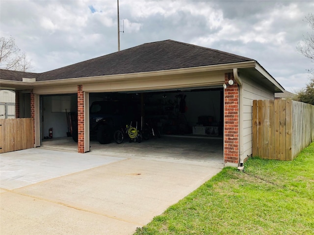 view of home's exterior featuring brick siding, a shingled roof, fence, concrete driveway, and a garage