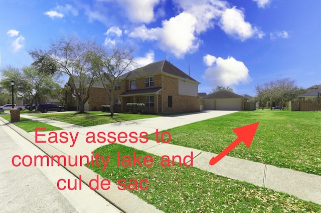 view of front of house featuring a front yard, brick siding, a garage, and driveway