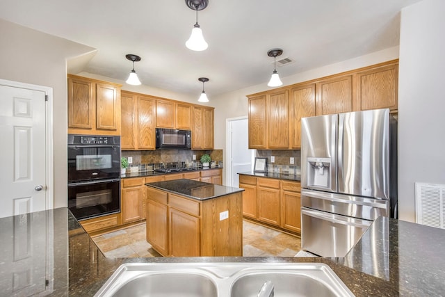 kitchen featuring black appliances, decorative light fixtures, tasteful backsplash, and visible vents