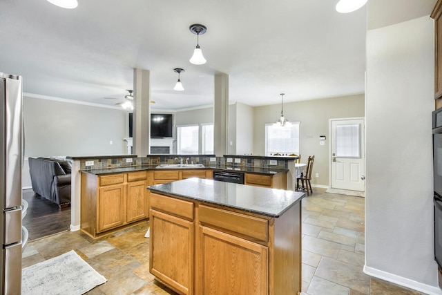 kitchen with a center island, ceiling fan, black dishwasher, freestanding refrigerator, and a sink