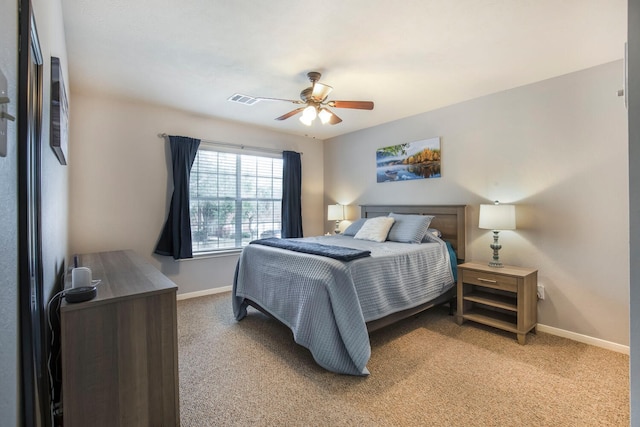 bedroom with visible vents, light carpet, baseboards, and ceiling fan