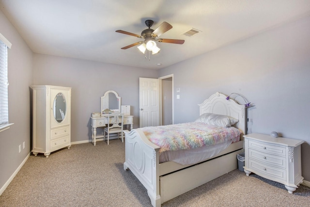 bedroom with visible vents, baseboards, light carpet, and ceiling fan