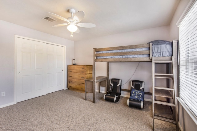 carpeted bedroom with baseboards, visible vents, and ceiling fan