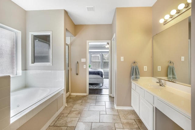 ensuite bathroom featuring visible vents, connected bathroom, ceiling fan, a garden tub, and vanity