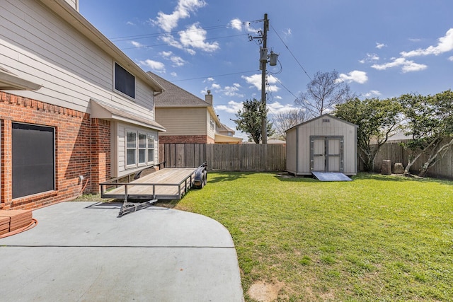 view of yard with a fenced backyard, a patio, an outdoor structure, and a shed