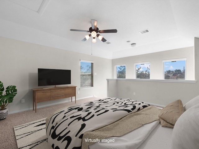 carpeted bedroom featuring visible vents, ceiling fan, and baseboards