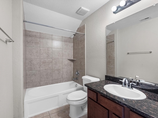 bathroom with visible vents, toilet, tile patterned floors, vanity, and shower / washtub combination