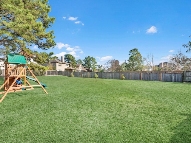 view of yard featuring a playground and a fenced backyard