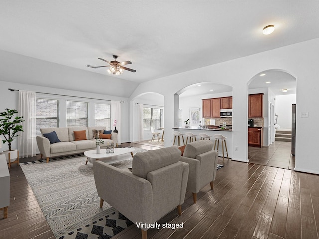 living area featuring dark wood-style floors, ceiling fan, lofted ceiling, and recessed lighting