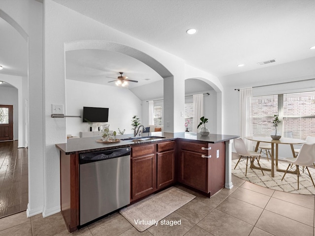 kitchen featuring visible vents, stainless steel dishwasher, a ceiling fan, open floor plan, and a sink