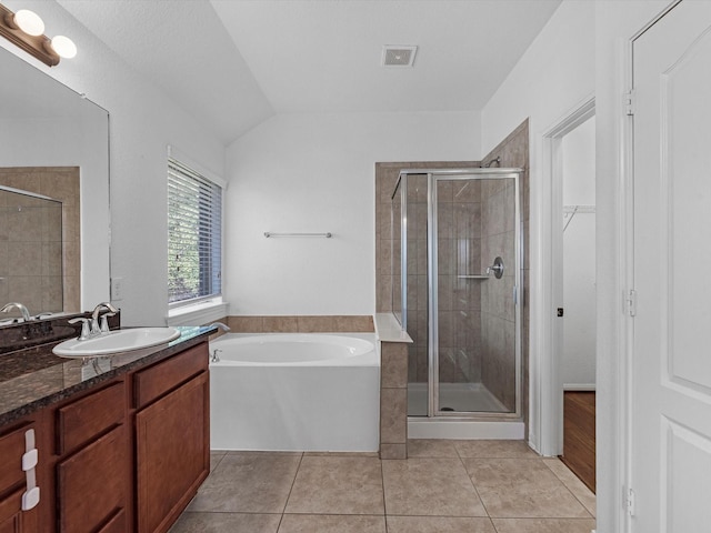 full bath featuring a stall shower, vanity, a garden tub, and tile patterned floors