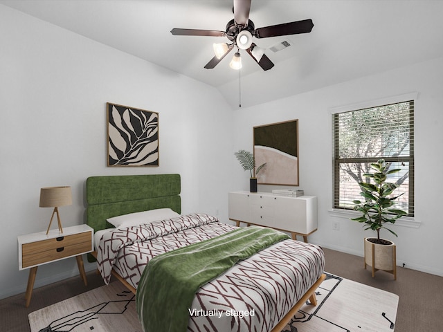 bedroom with carpet floors, lofted ceiling, visible vents, ceiling fan, and baseboards