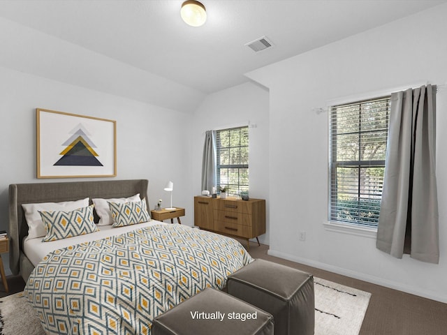 bedroom featuring visible vents, vaulted ceiling, and baseboards