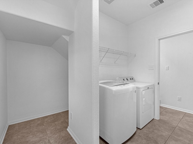 laundry area featuring laundry area, baseboards, visible vents, and washer and clothes dryer