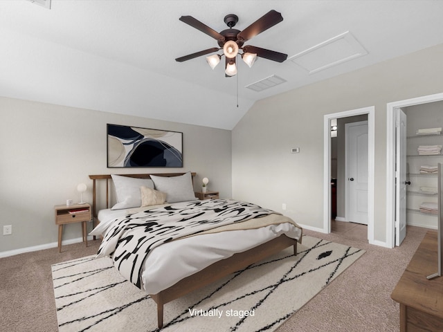 carpeted bedroom featuring lofted ceiling, attic access, visible vents, and baseboards