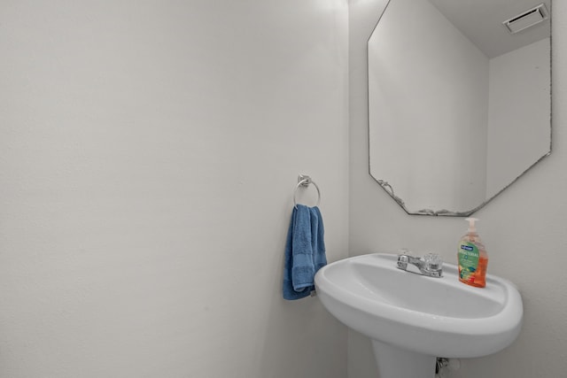 bathroom with visible vents and a sink