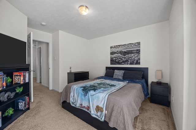 carpeted bedroom with a textured ceiling and baseboards