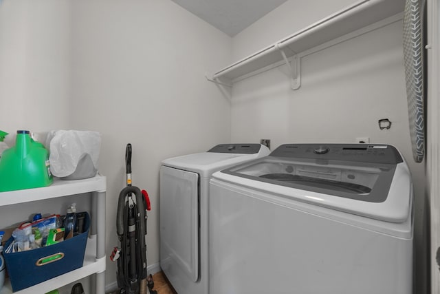 clothes washing area featuring laundry area and washing machine and clothes dryer