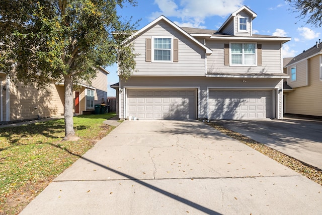 view of property featuring driveway and an attached garage