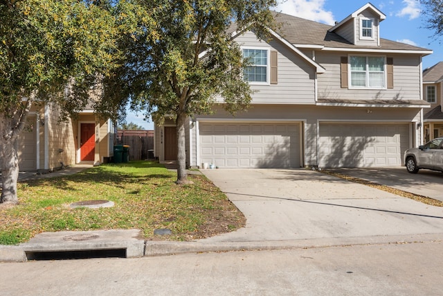 view of front of property with driveway, an attached garage, and a front yard