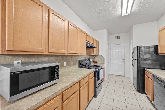 kitchen with light brown cabinets, under cabinet range hood, light countertops, black appliances, and tasteful backsplash