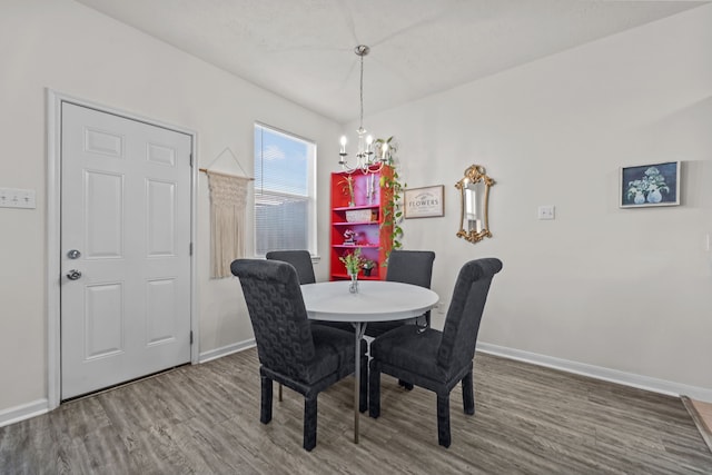 dining room featuring baseboards, an inviting chandelier, and wood finished floors