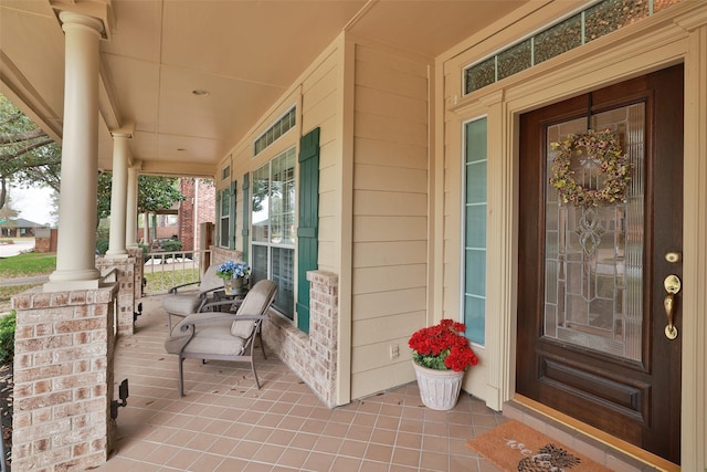 view of exterior entry featuring a porch