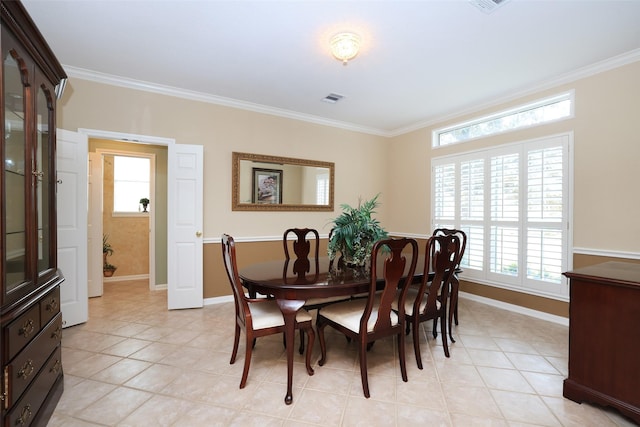 dining space featuring crown molding, visible vents, plenty of natural light, and baseboards