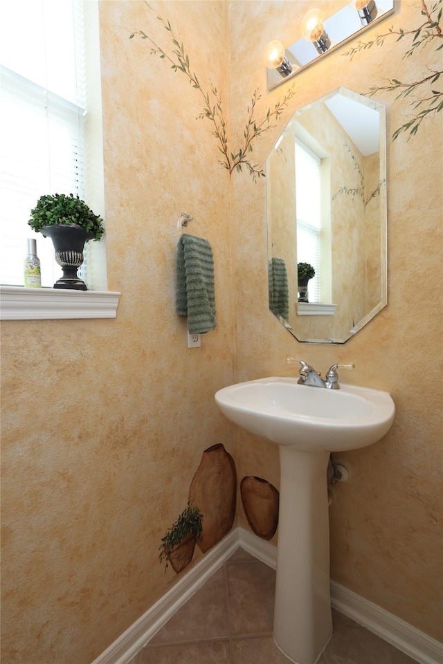 bathroom featuring tile patterned flooring and baseboards