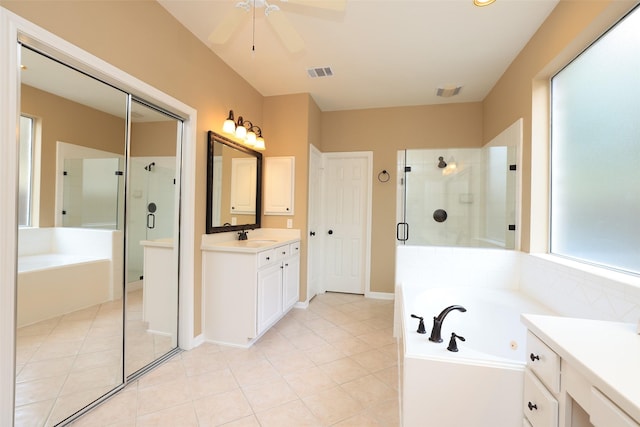 bathroom featuring vanity, a shower stall, a bath, and tile patterned floors