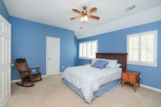 bedroom featuring vaulted ceiling, carpet, visible vents, and baseboards