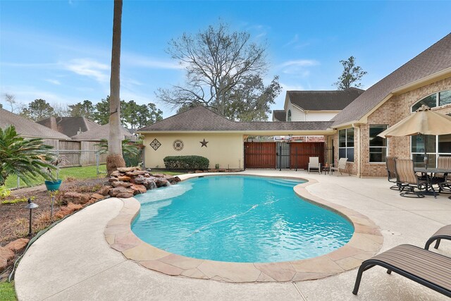 view of swimming pool with fence, a fenced in pool, and a patio