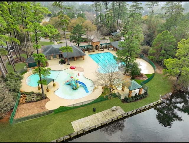 pool with a water view, a yard, a water play area, and a patio