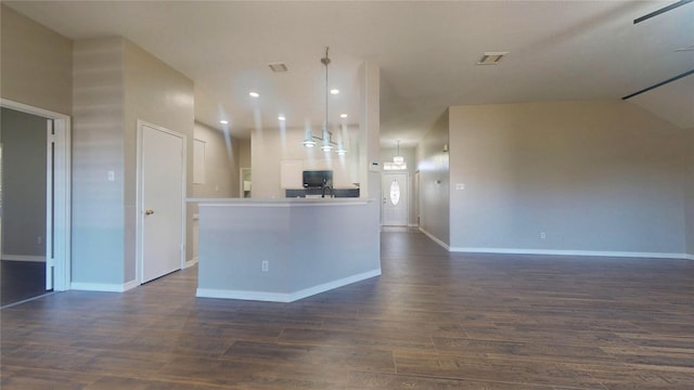 kitchen with open floor plan, visible vents, black microwave, and dark wood-style flooring