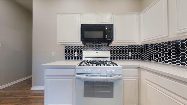 kitchen featuring decorative backsplash, light countertops, gas range gas stove, and black microwave