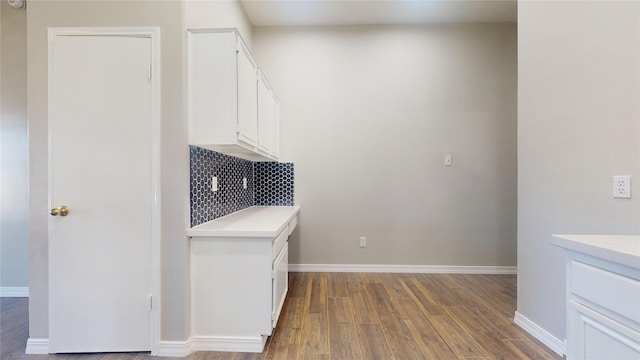 interior space with dark wood finished floors and baseboards