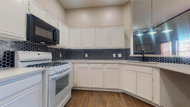 kitchen with white gas range, light countertops, black microwave, and a sink