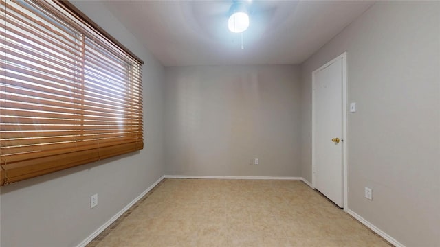 spare room with baseboards