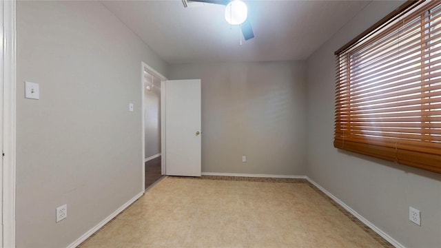 unfurnished room with baseboards