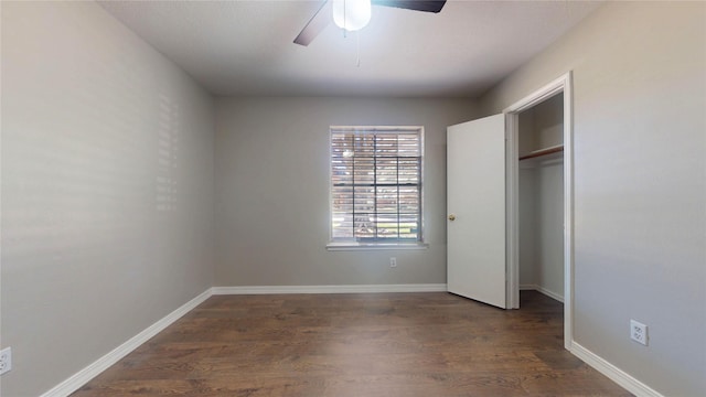 unfurnished bedroom featuring dark wood-style floors, ceiling fan, a closet, and baseboards